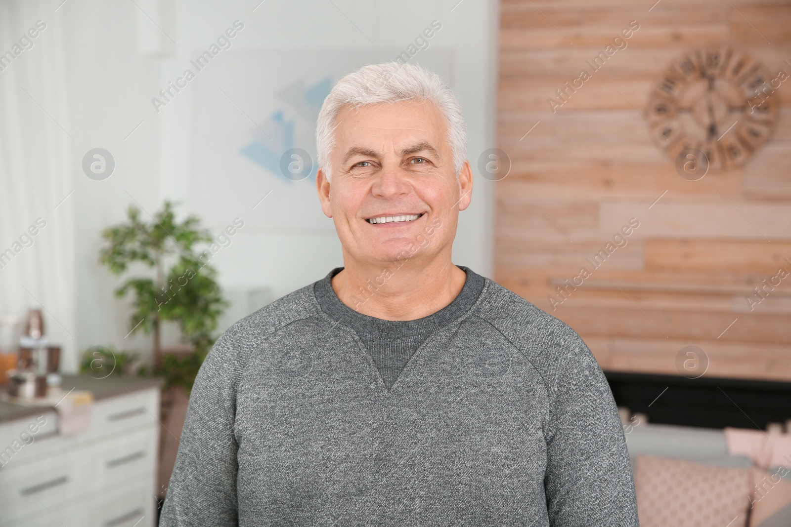 Photo of Portrait of mature man laughing at home