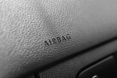 Photo of Safety airbag sign on dashboard in car, closeup
