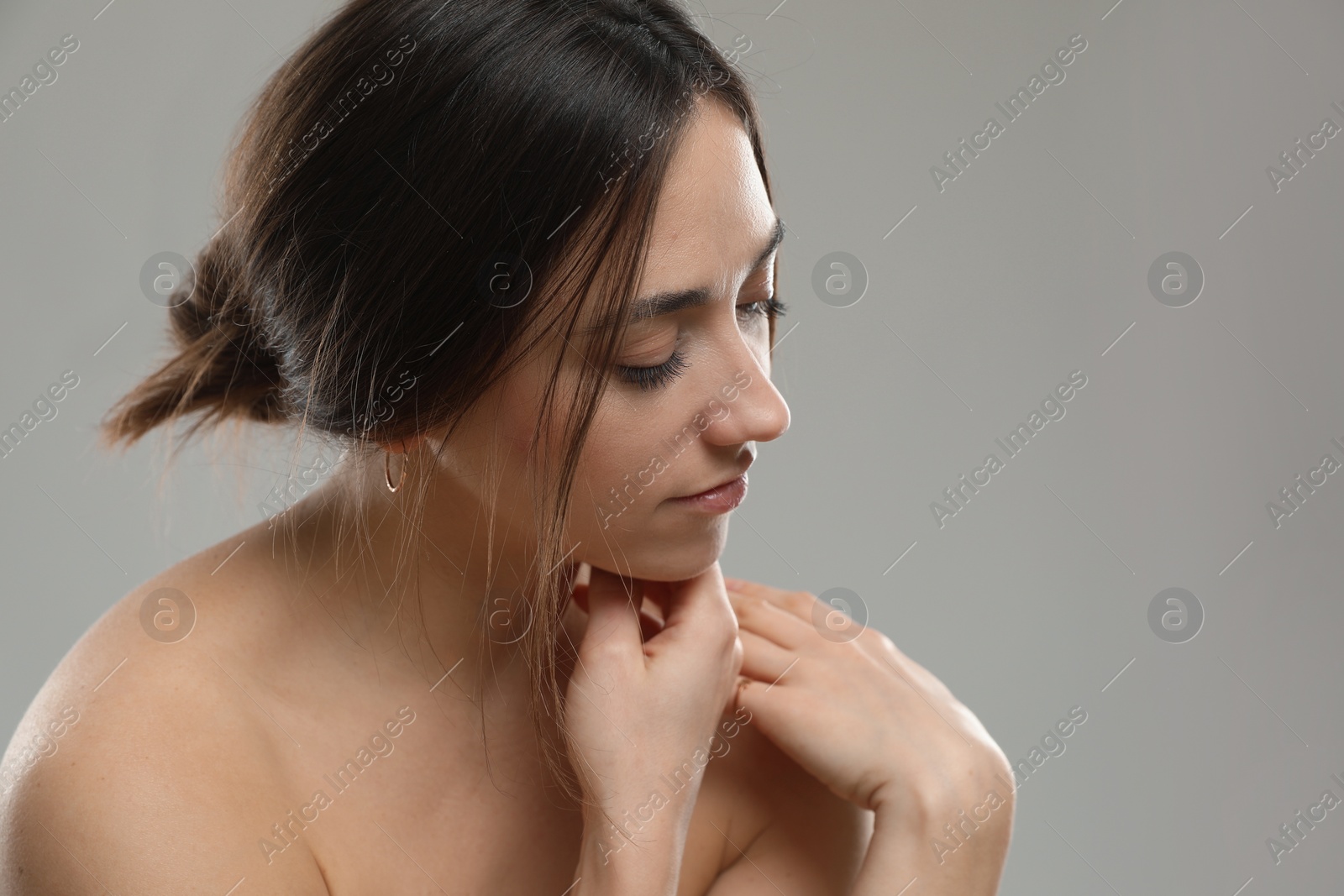 Photo of Portrait of beautiful woman on grey background