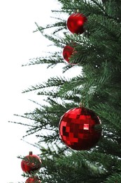 Photo of Beautiful Christmas tree with red baubles on white background, closeup