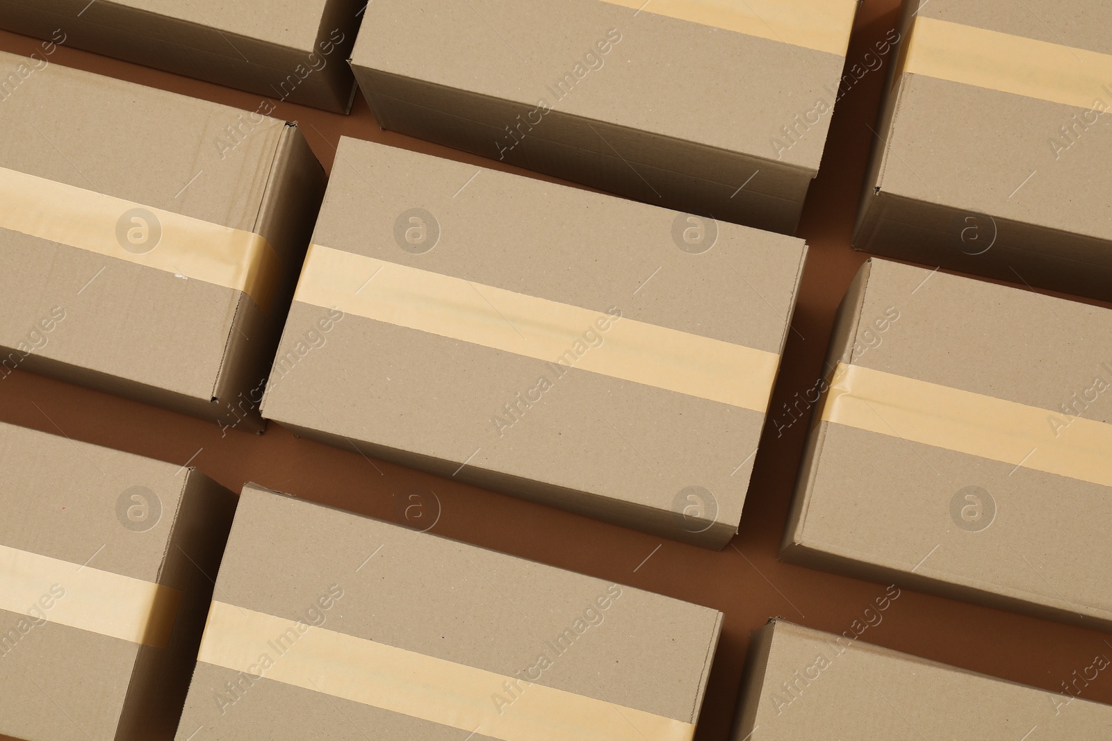 Photo of Many cardboard boxes on brown background, flat lay