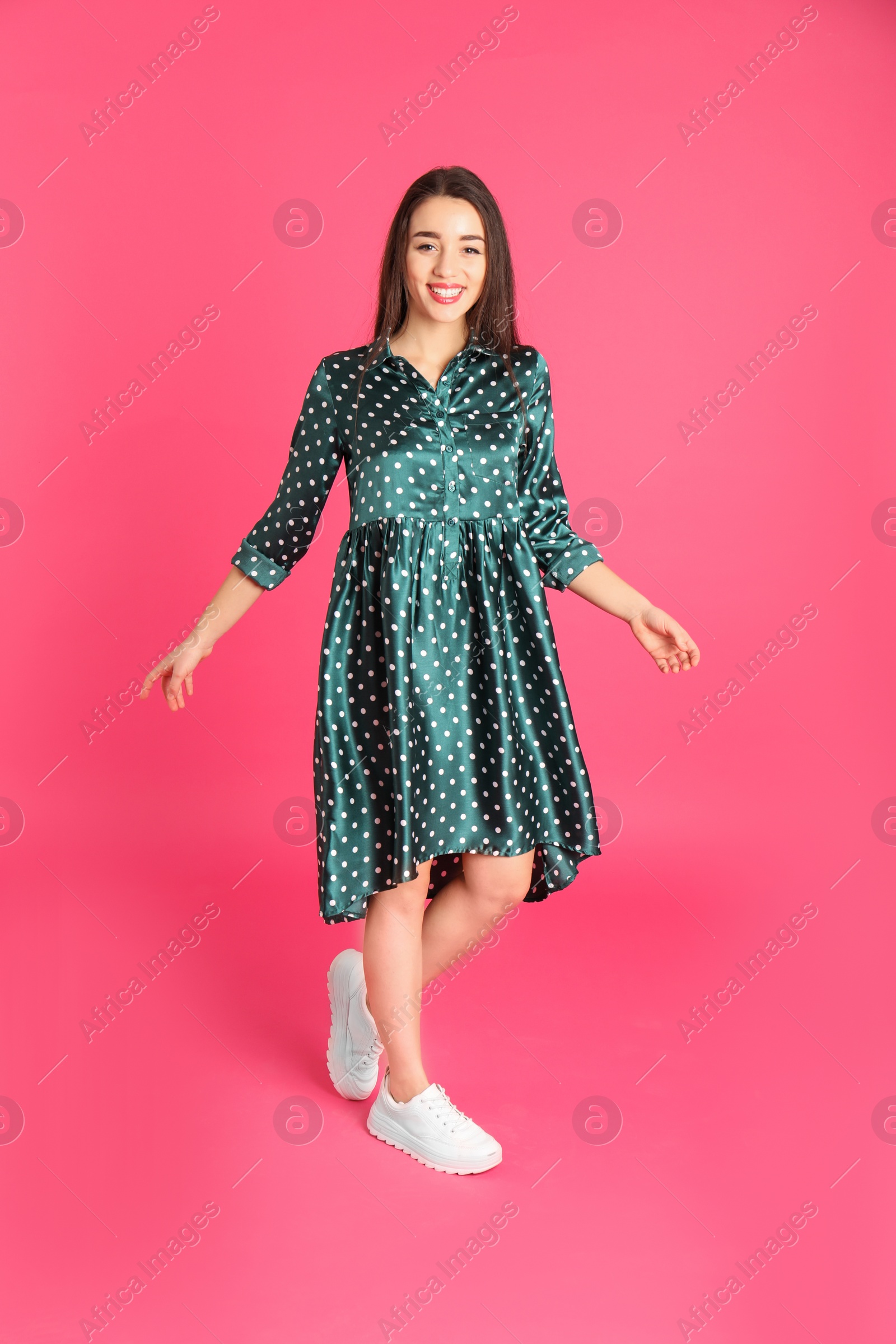 Photo of Portrait of beautiful young woman in stylish dress on color background