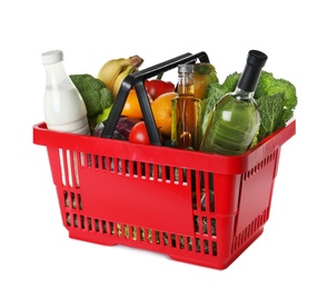 Photo of Shopping basket with grocery products on white background