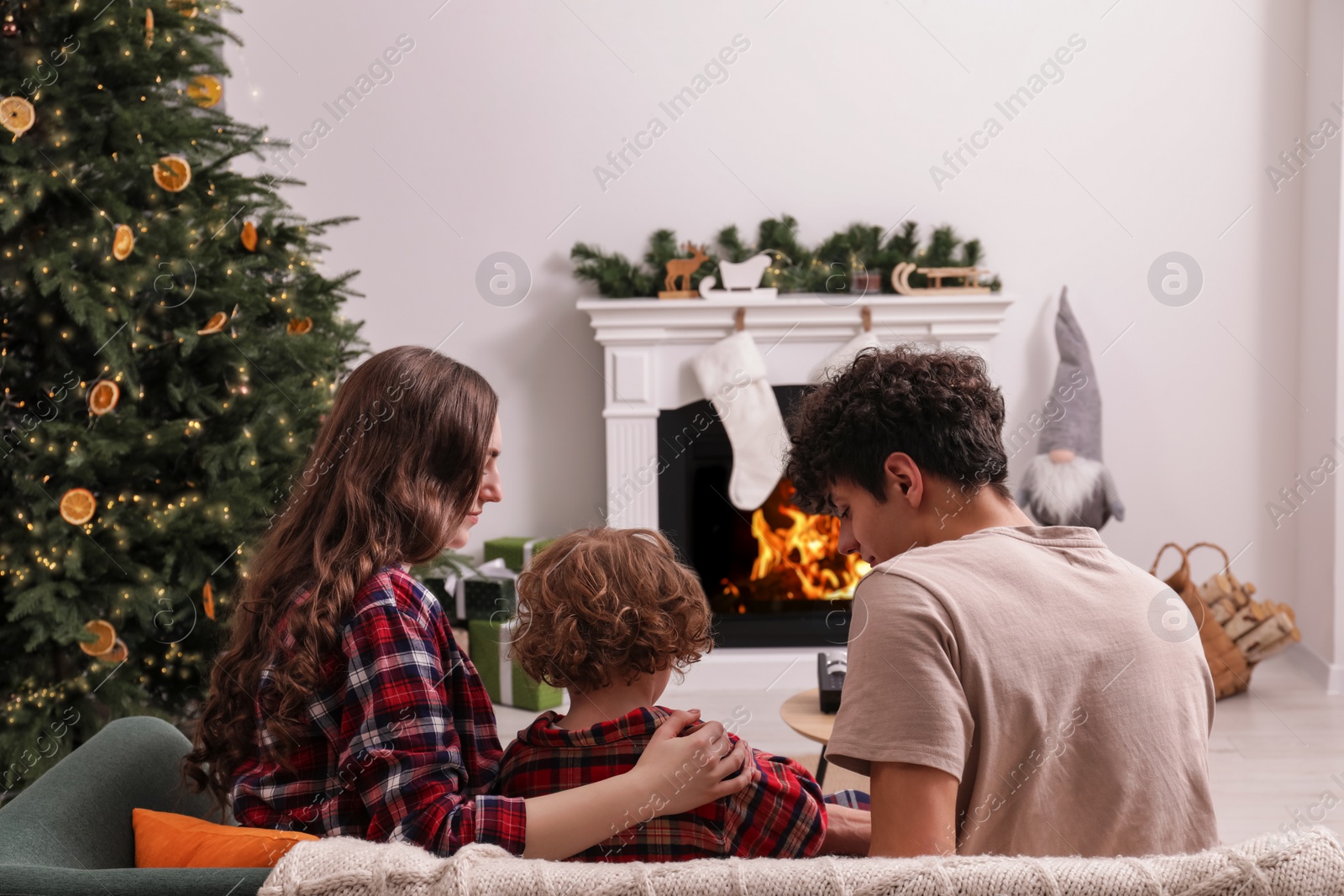 Photo of Family spending time together at home, back view. Watching movie via video projector