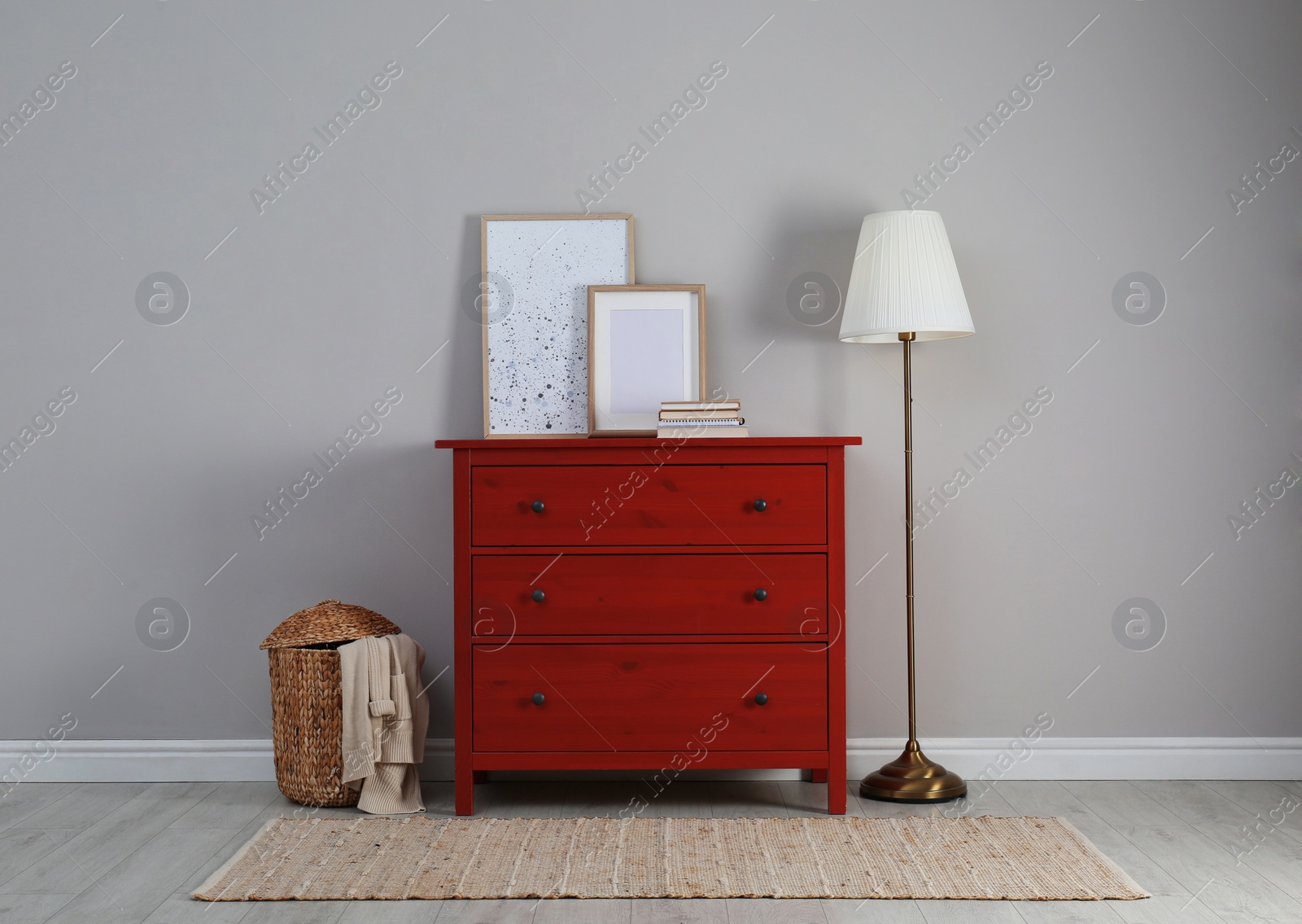 Photo of Modern room interior with chest of drawers near light wall