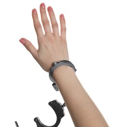 Freedom concept. Woman with handcuffs on her hand against white background, closeup