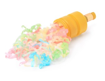 Photo of Colorful streamers with yellow party cracker isolated on white