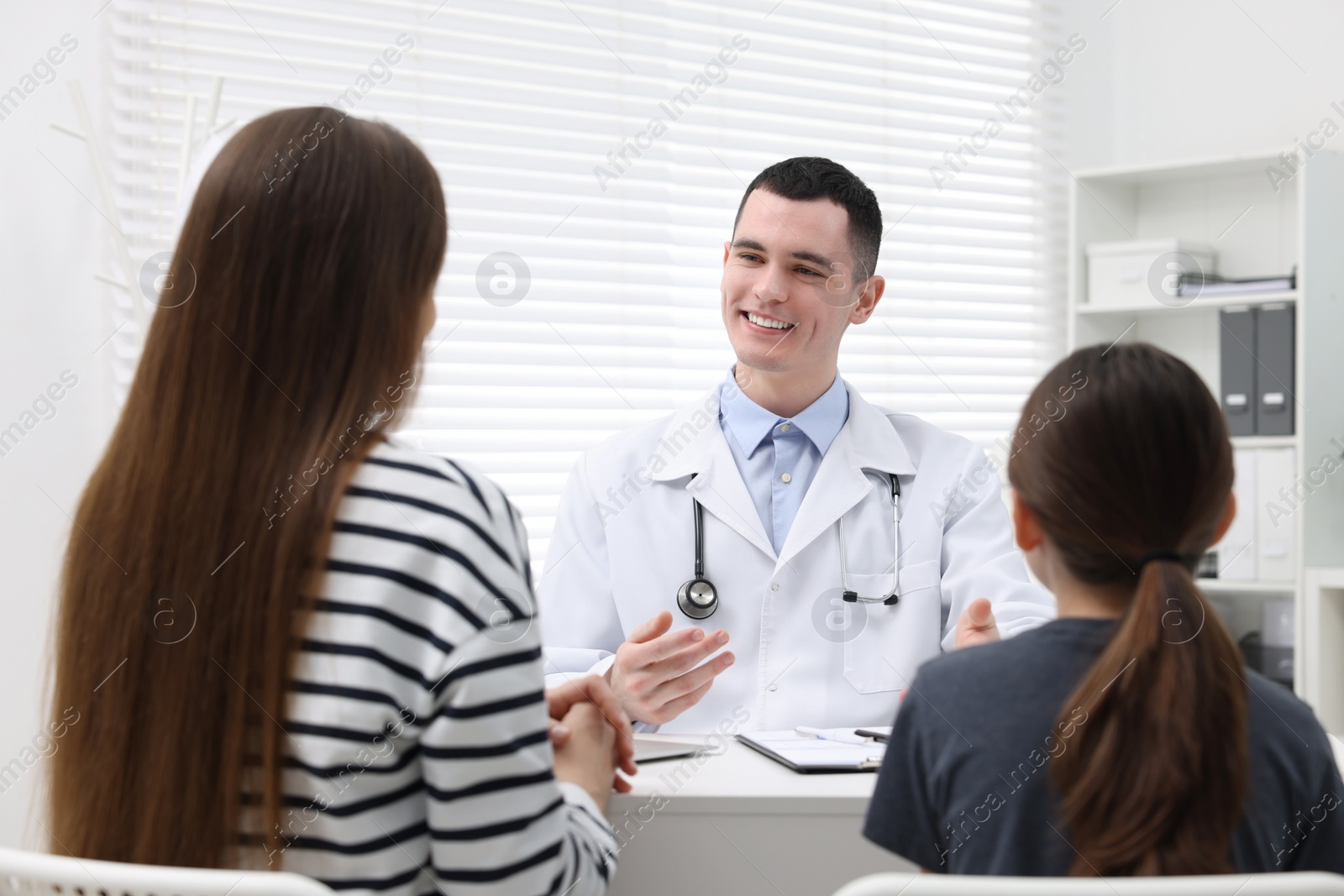 Photo of Gastroenterologist consulting woman and her daughter in clinic