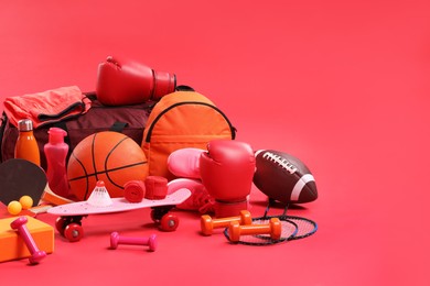 Photo of Many different sports equipment on red background, space for text