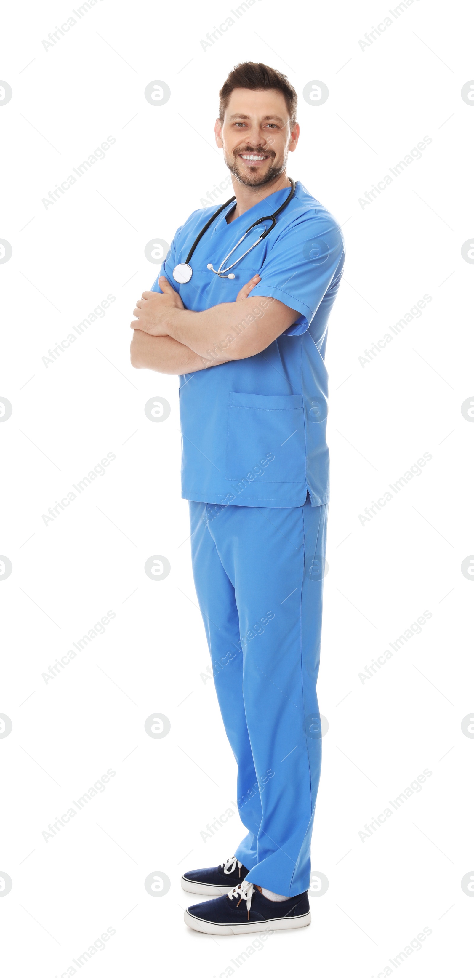 Photo of Full length portrait of smiling male doctor in scrubs isolated on white. Medical staff