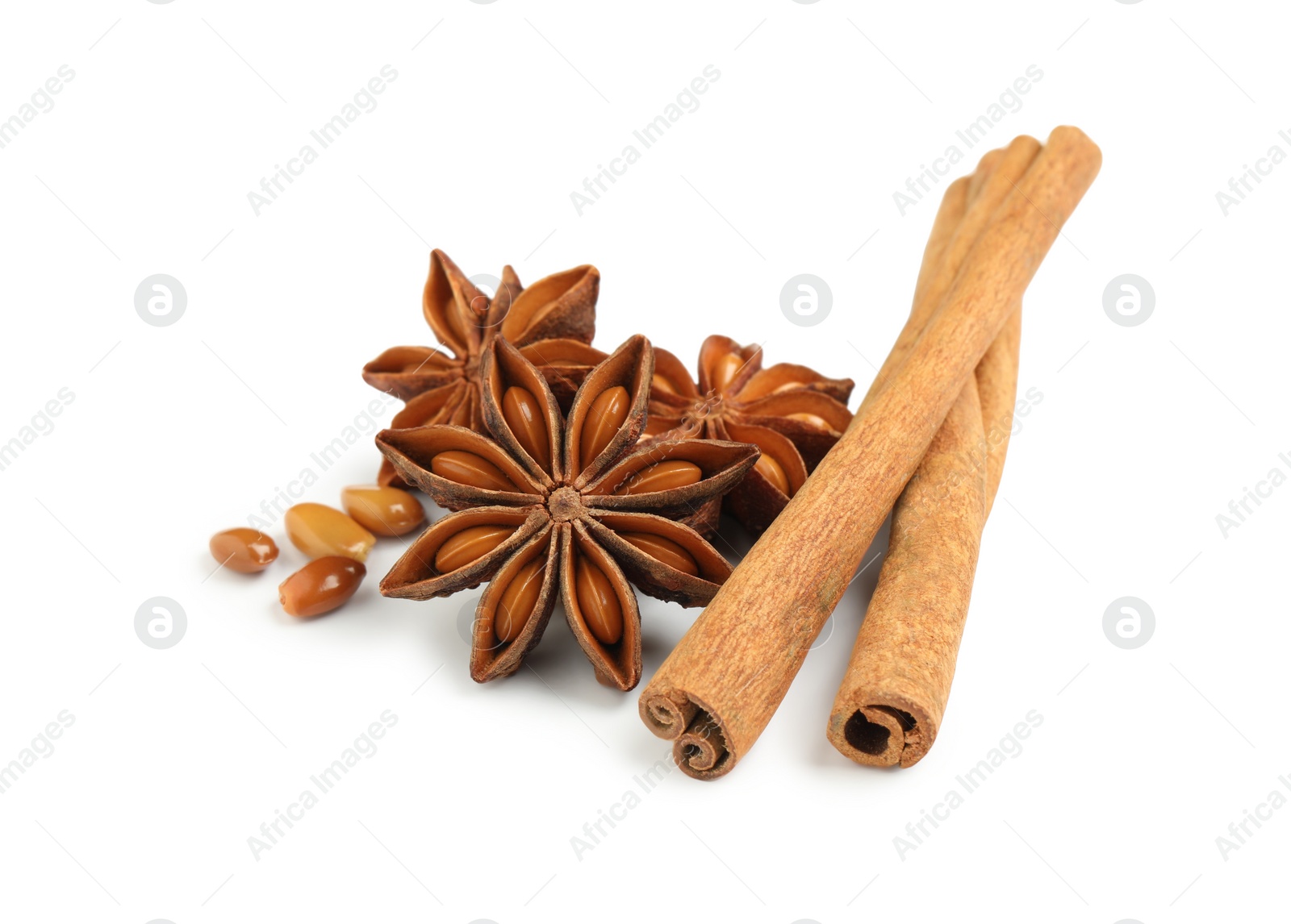 Photo of Dry anise stars and cinnamon sticks on white background