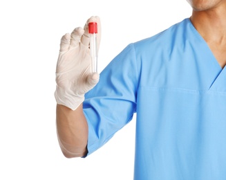 Photo of Male doctor holding empty test tube on white background, closeup. Medical object