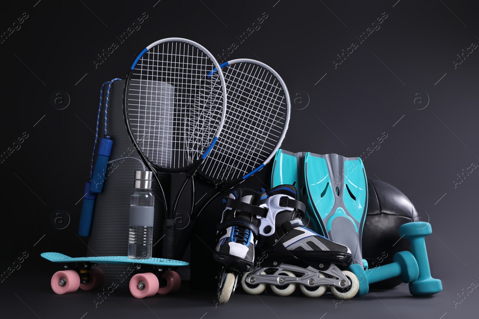 Photo of Set of different sports equipment on black background