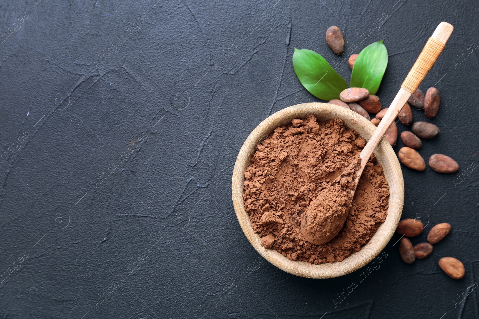 Photo of Bowl with cocoa powder on grey background, top view