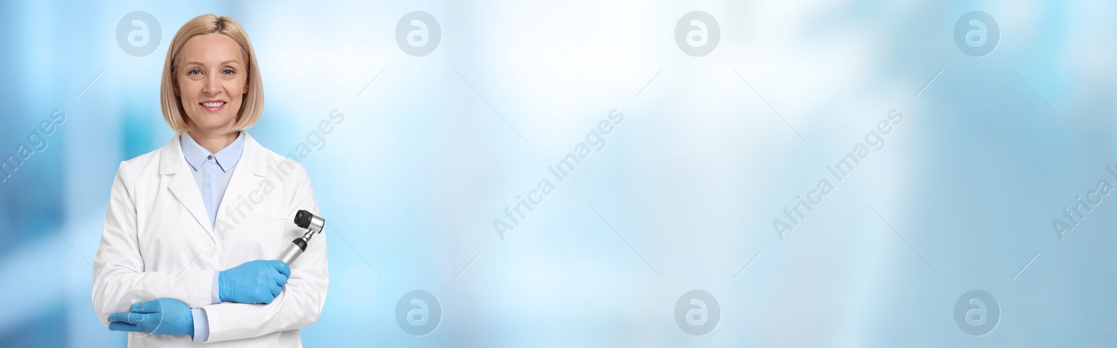 Image of Professional dermatologist with dermatoscope on blurred background, space for text. Banner design