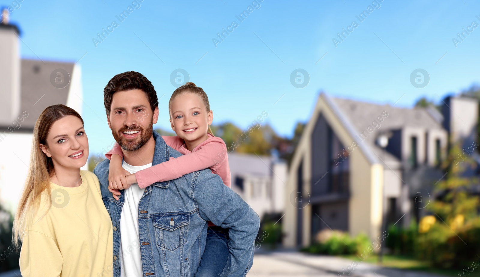 Image of Portrait of happy family with child on street