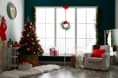 Stylish room interior with decorated Christmas tree