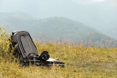 Photo of Backpack and photographer's equipment on grass outdoors