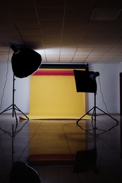 Photo of Interior of modern photo studio with professional lighting equipment