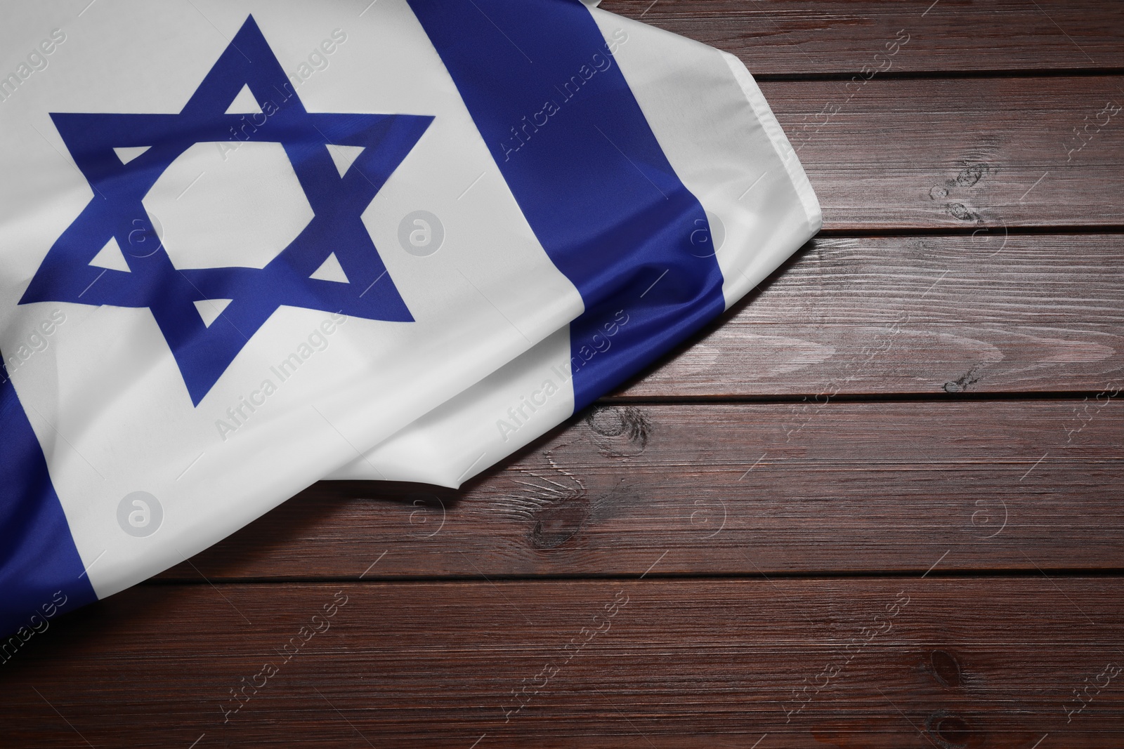 Photo of Flag of Israel on wooden background, top view and space for text. National symbol