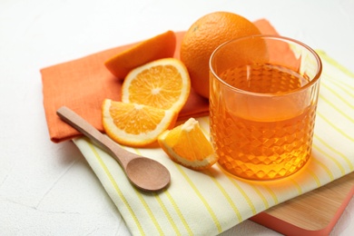 Photo of Board with tasty jelly and orange slices on light table, space for text