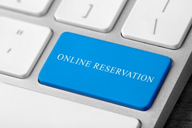 Image of Light blue button with text Online Reservation on keyboard, closeup view