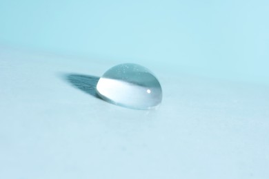 Photo of Macro photo of water drop on light blue background