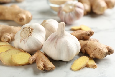 Photo of Ginger and fresh garlic on table. Natural cold remedies