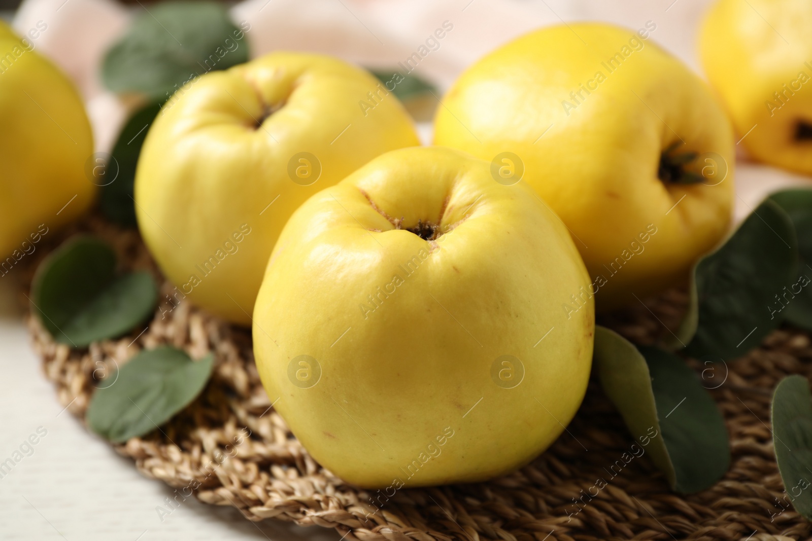 Photo of Fresh ripe organic quinces with leaves on table