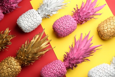 Photo of Many white, pink and golden pineapples on color background, flat lay. Creative concept