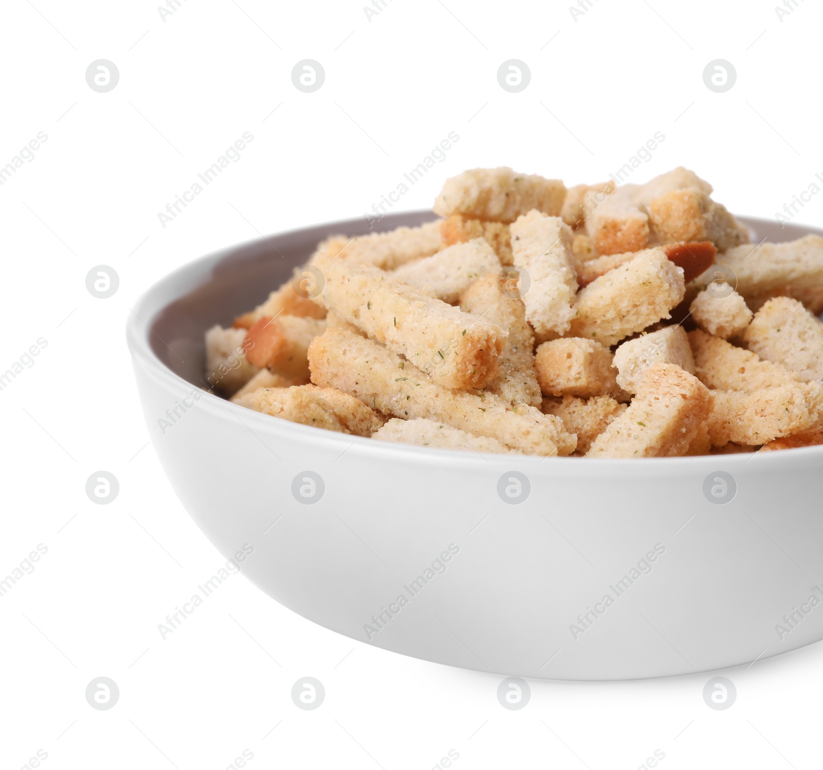 Photo of Crispy rusks with seasoning in bowl isolated on white