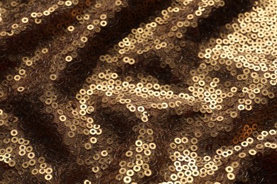 Beautiful golden sequin fabric as background, closeup