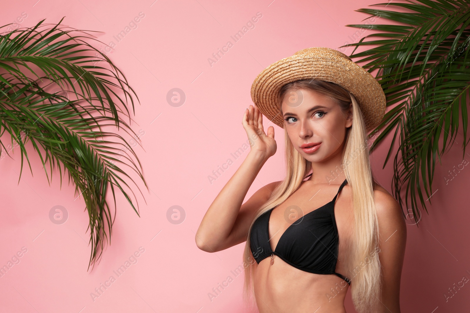 Photo of Pretty young woman wearing stylish bikini on pink background