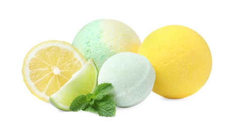 Photo of Citrus bath bombs and fresh fruits with mint on white background