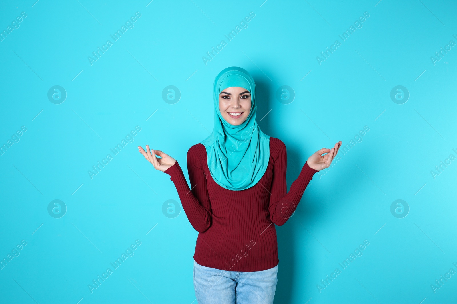 Photo of Portrait of young Muslim woman in hijab against color background