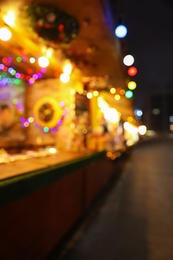 Blurred view of Christmas fair stalls outdoors at night