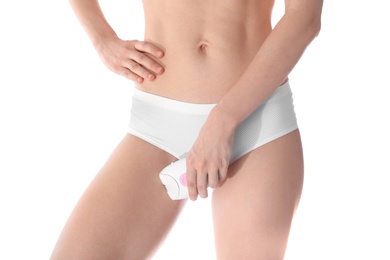 Young woman doing bikini epilation procedure on white background, closeup