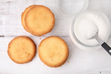 Photo of Tasty sweet sugar cookies on white wooden table, top view