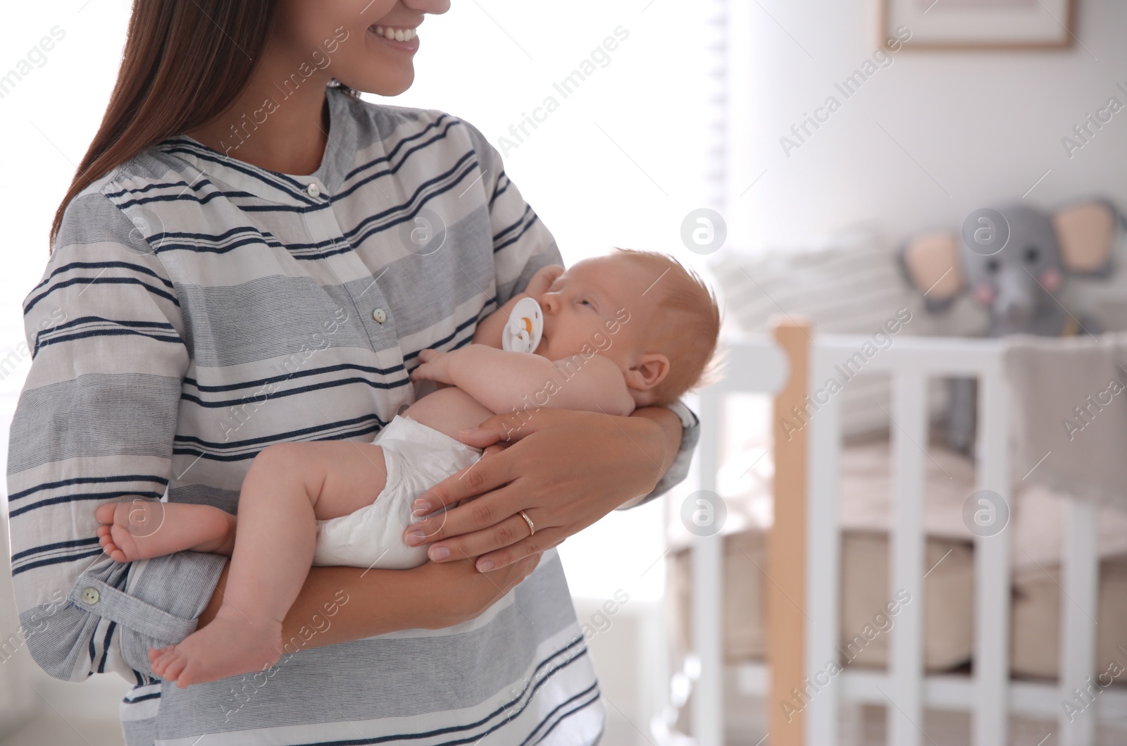 Photo of Mother with her newborn baby at home, closeup