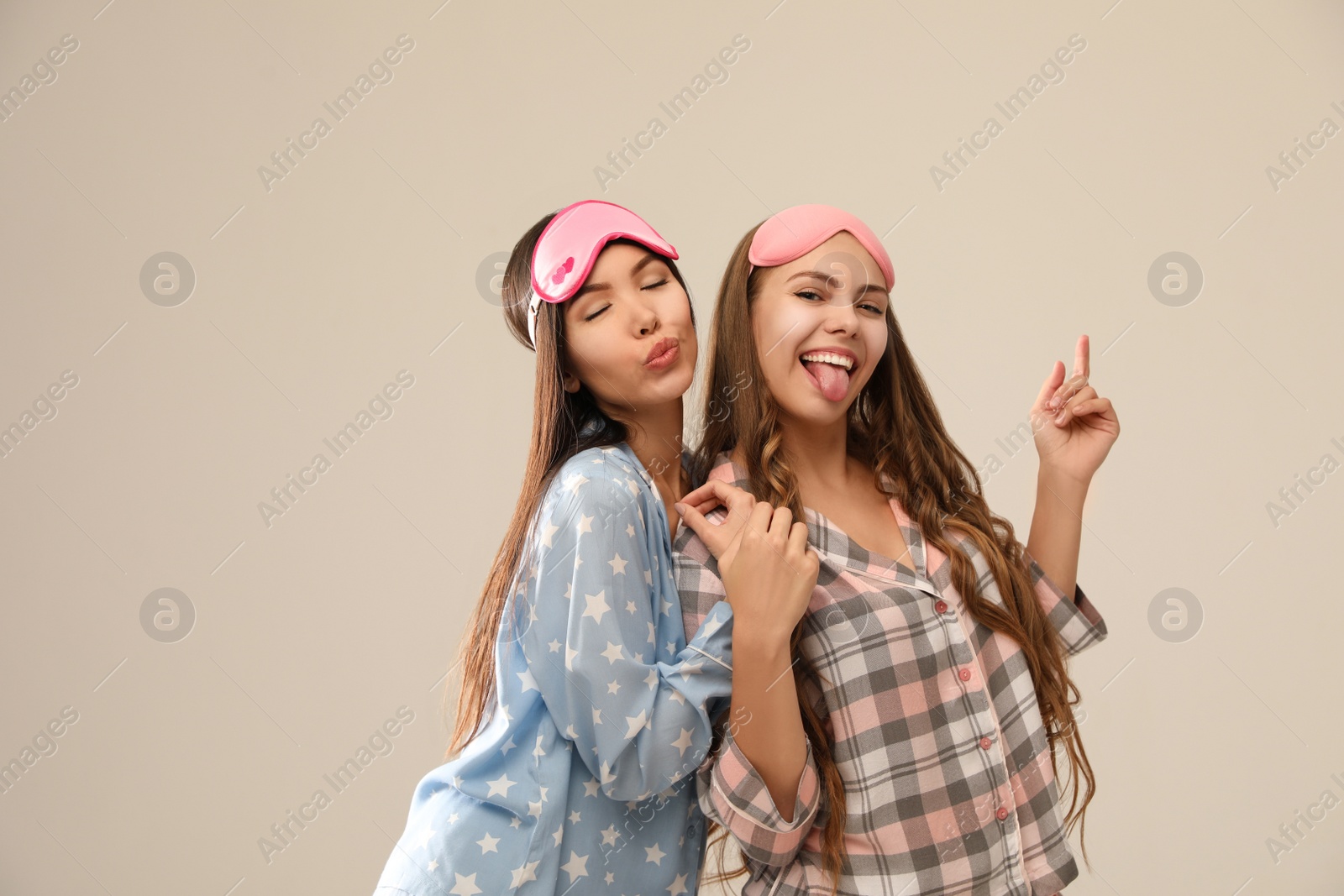 Photo of Beautiful women in pajamas on beige background. Bedtime