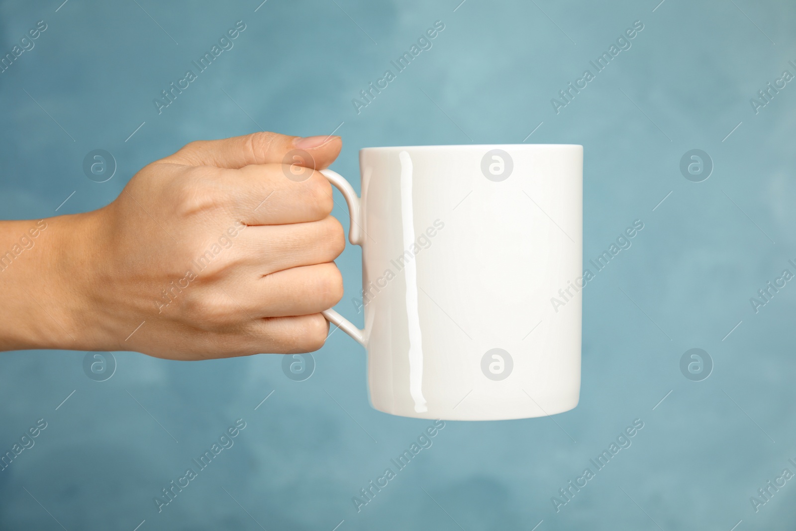 Photo of Woman holding ceramic cup on color background. Mock up for design