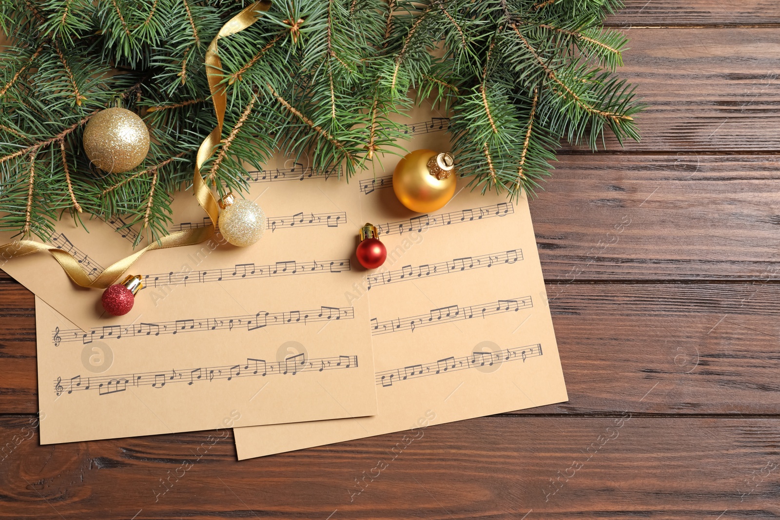 Photo of Flat lay composition with Christmas decorations and music sheets on wooden background