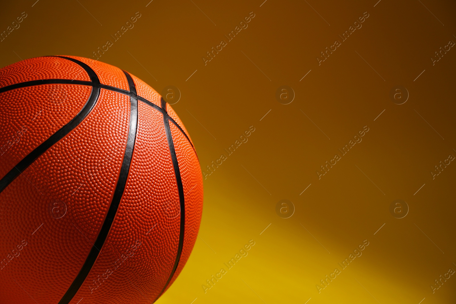 Photo of Basketball ball on color background, closeup. Space for text