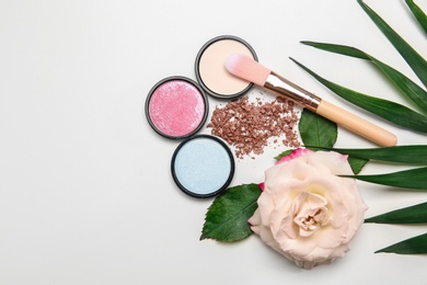 Photo of Flat lay composition with makeup brush, cosmetic products  and rose on white background