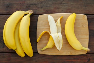 Delicious bananas on wooden table, flat lay