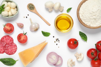 Flat lay composition with fresh ingredients for pizza on white background