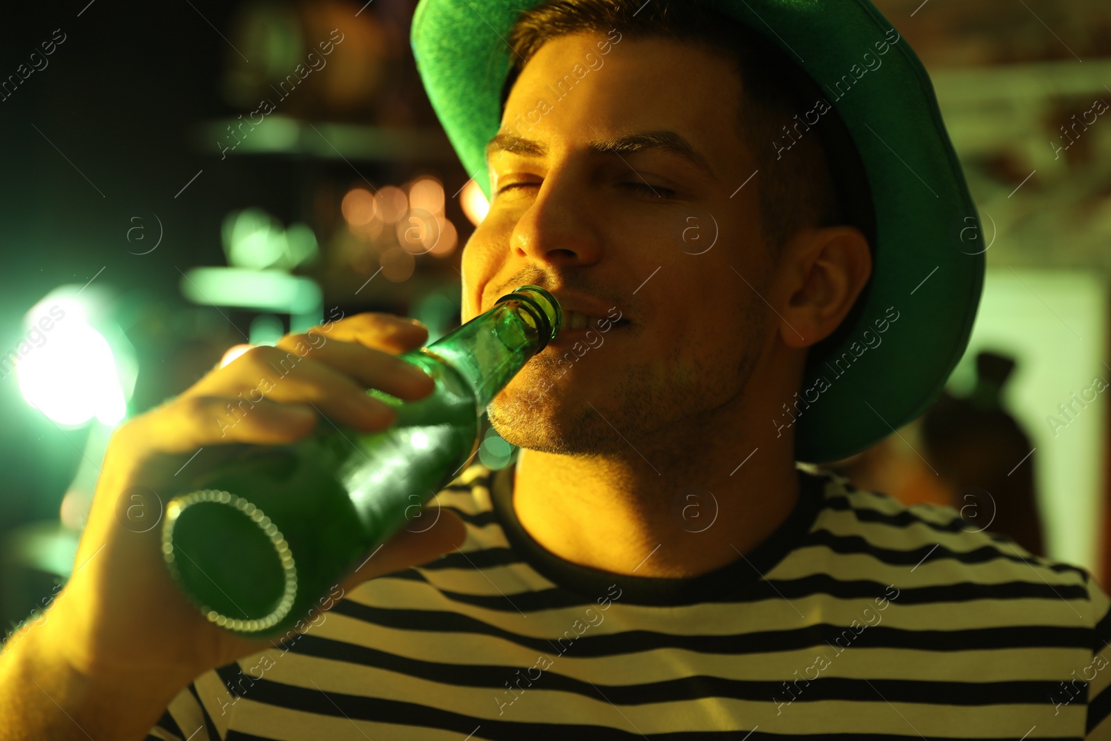 Photo of Man with beer celebrating St Patrick's day in pub, closeup