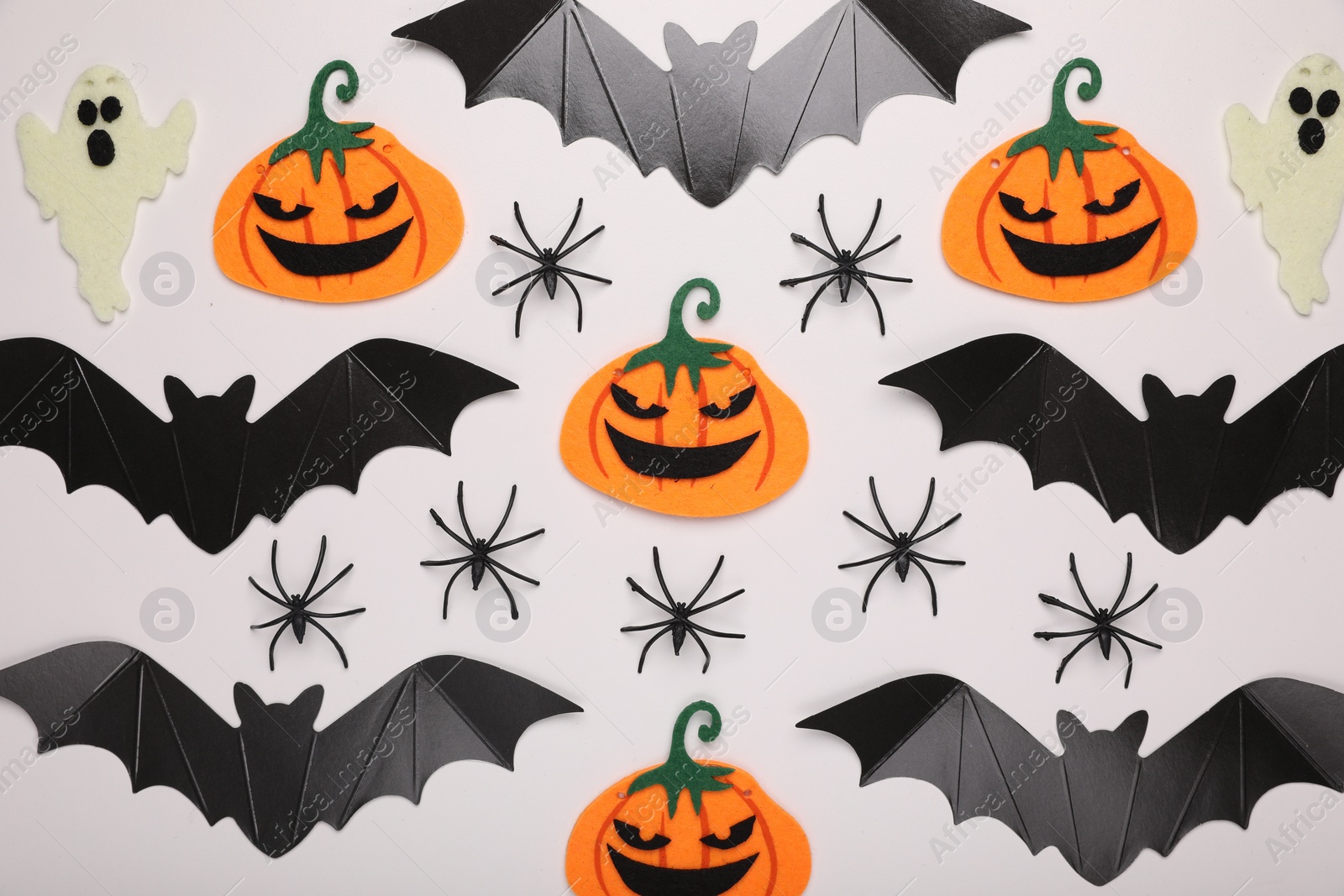 Photo of Flat lay composition with Halloween decor on white background