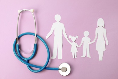 Photo of Stethoscope and paper cutout of family on color background, top view