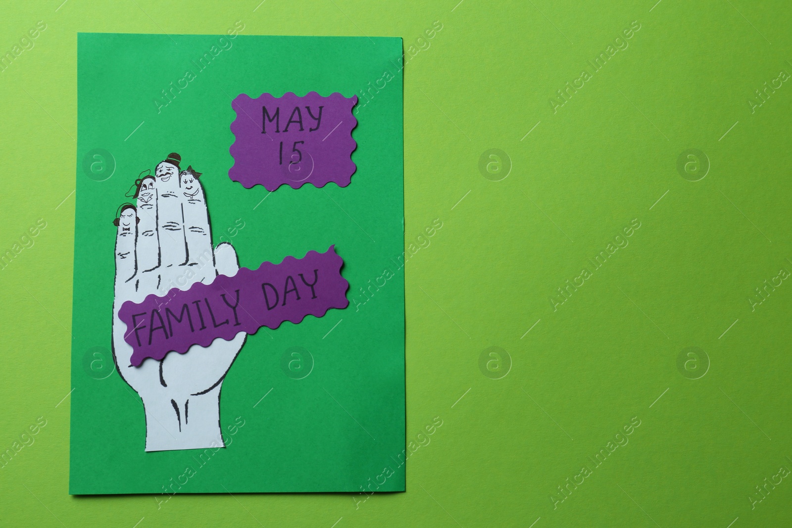 Photo of Paper cards with words Family Day and hand cutout on light green background, top view. Space for text